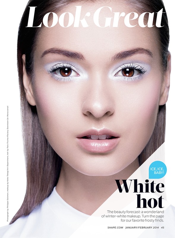 Close-up studio shot of a woman wearing winter-white makeup with glossy lips; beauty and fashion concept for a magazine cover.