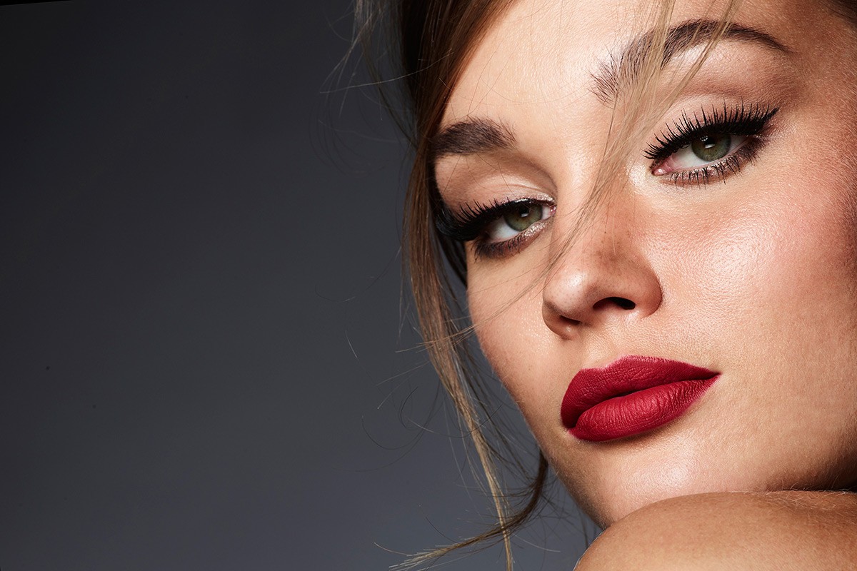 Close-up beauty portrait of a woman with bold red lips and winged eyeliner by make-up artist Keiko Takagi.
