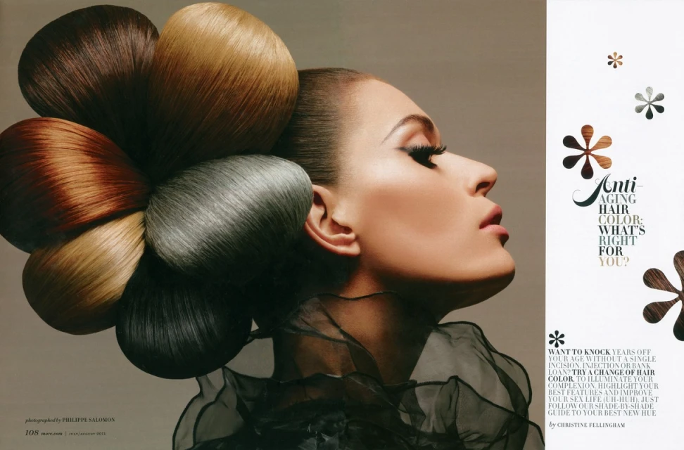 Profile portrait of a woman with a flower-shaped updo of different colored hair extensions for a hair color advertisement.