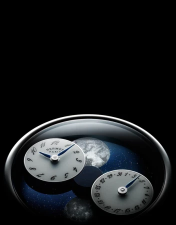 Hermès watch featuring time and date dials against a celestial background, all encased in a sleek, modern design with a black backdrop.