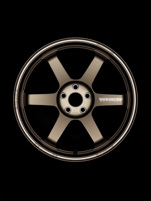 Bronze-toned six-spoke car wheel with silver rim on black backdrop, automotive part, transportation design, aftermarket car product photography.