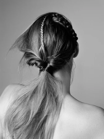 Monochrome rear view portrait of a person with long braided and twisted hair styled in Los Angeles by Kenna.