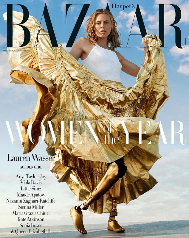Harper's Bazaar magazine cover featuring Lauren Wasser in a flowing gold dress. She has prosthetic legs and is posing confidently.