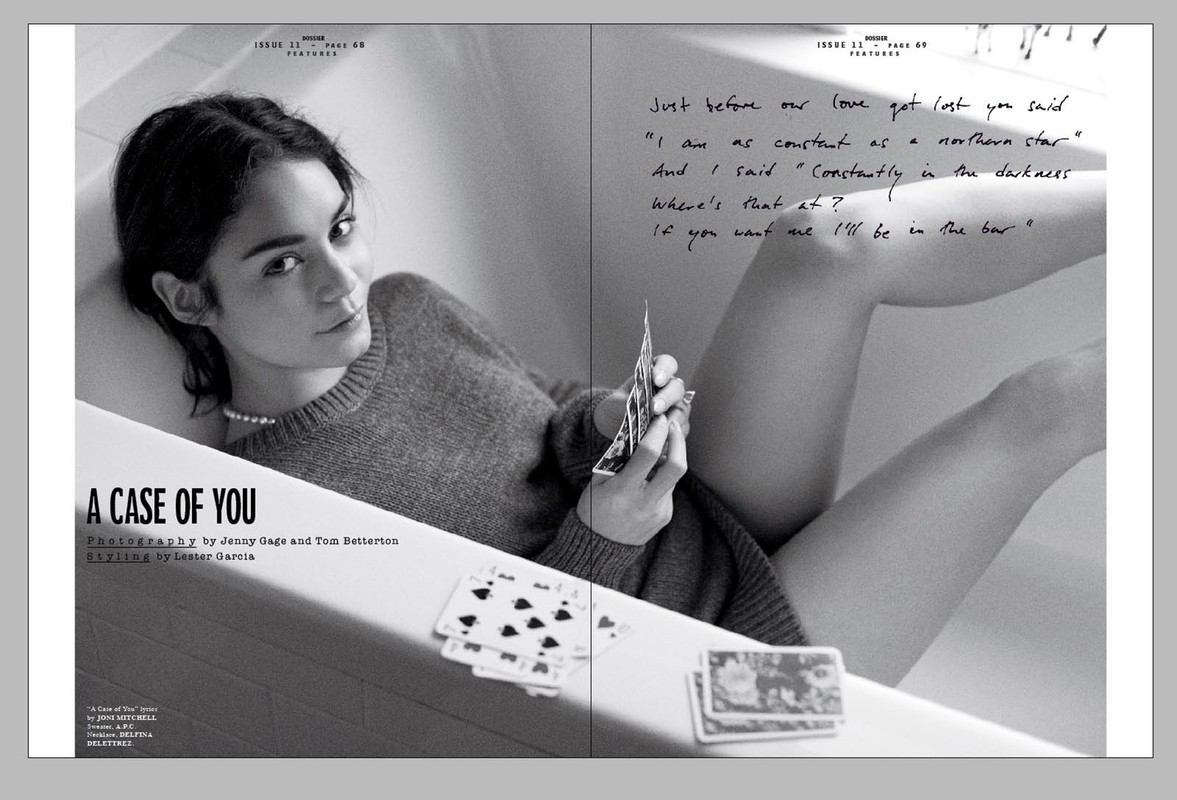 Black-and-white fashion editorial shot of a woman in a bathtub holding playing cards, featuring shallow depth of field and magazine layout.