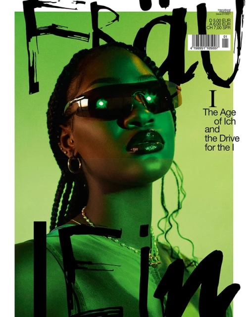 Magazine cover featuring a woman with sunglasses and braids, shot in green lighting with bold typography.