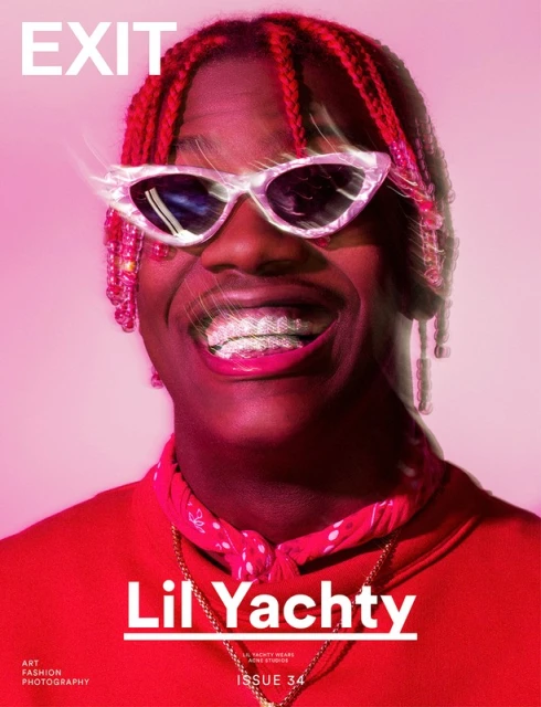 Magazine cover featuring rapper Lil Yachty with braids and sparkling grill, wearing sunglasses and a red bandana, set against a pink background.