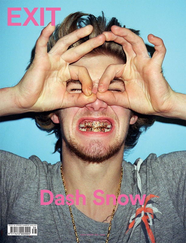 Magazine cover featuring a young adult male with styled hair, gold teeth grill, and hands forming makeshift binoculars in front of blue backdrop.
