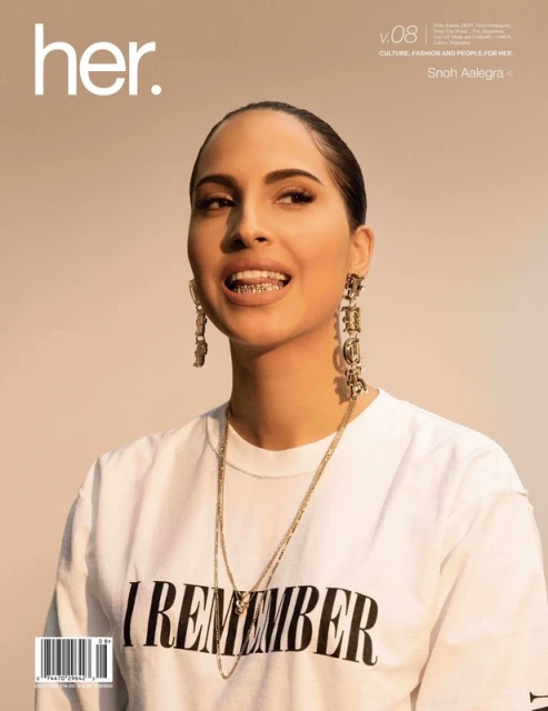 Magazine cover featuring a woman with gold jewelry and a white t-shirt, set against a soft beige background.