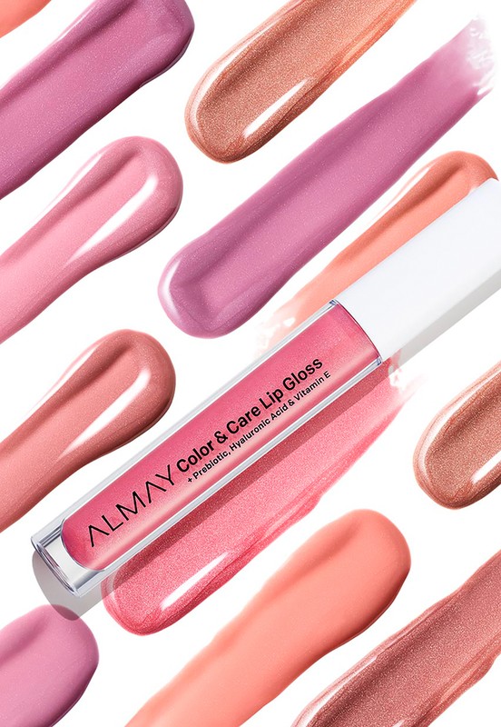 Almay Color & Care Lip Gloss product shot with pink hues and glossy texture, makeup concept for beauty and cosmetic industry on white backdrop.