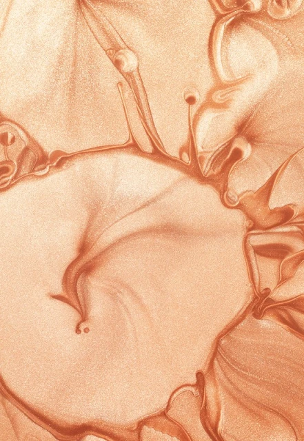 Abstract close-up of a copper-toned fluid art piece with shimmering texture and flowing patterns, creating a dynamic and captivating composition.