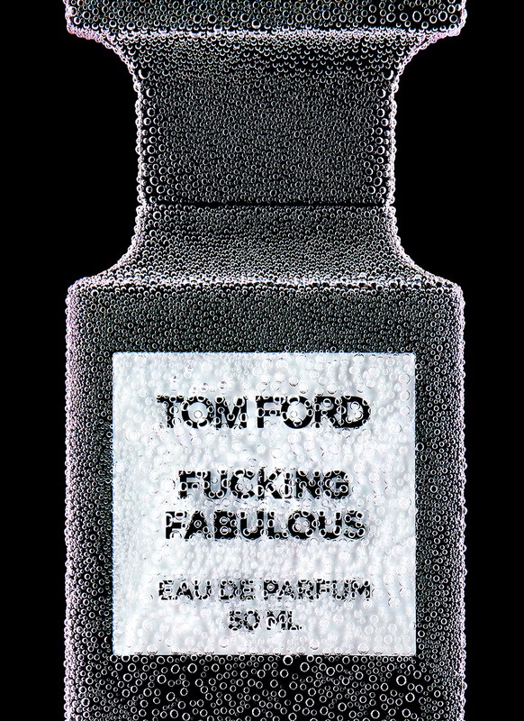 Tom Ford 'Fucking Fabulous' Eau de Parfum bottle close-up, covered in bubbles, black background, minimalist beauty and luxury concept.