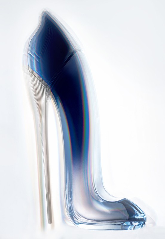 Elegant blue high-heel shoe on a bright white background, showcasing a blurred motion effect in a studio setting, fashion-forward footwear.