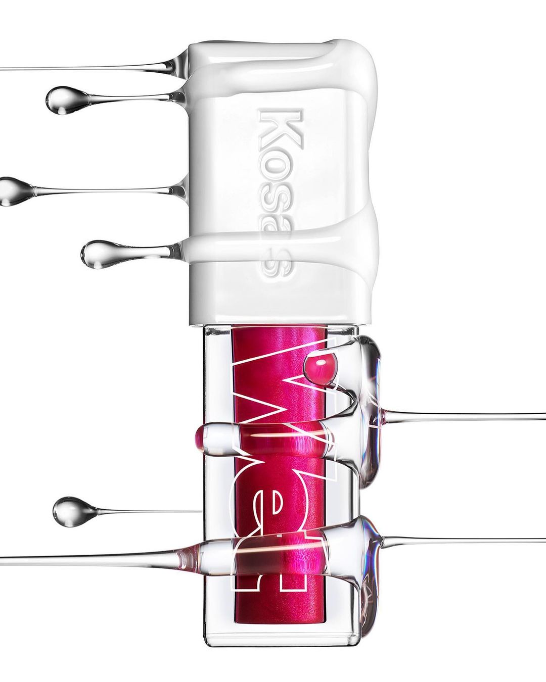 Kosas lip gloss product shot on a white background, featuring a pink color and a glossy texture, accented by clear liquid drips.