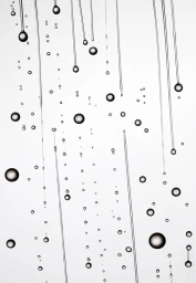 Monochrome macro photography of falling water droplets and thin streams on a bright white background