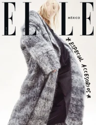 Magazine cover featuring a blonde model wearing a textured grey coat against a plain white background