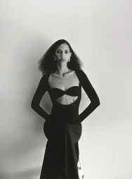 Black and white portrait of a woman wearing a long-sleeved cut-out black dress styled by Lara Backmender.