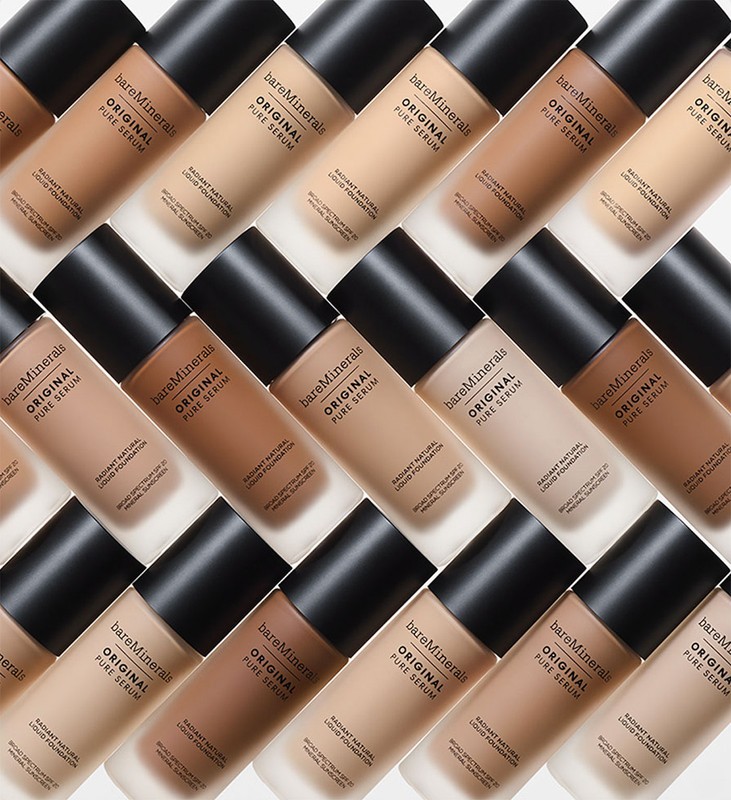 Multiple bottles of bareMinerals Original Pure Serum foundation arranged in a grid pattern, showcasing the different shades of foundation.