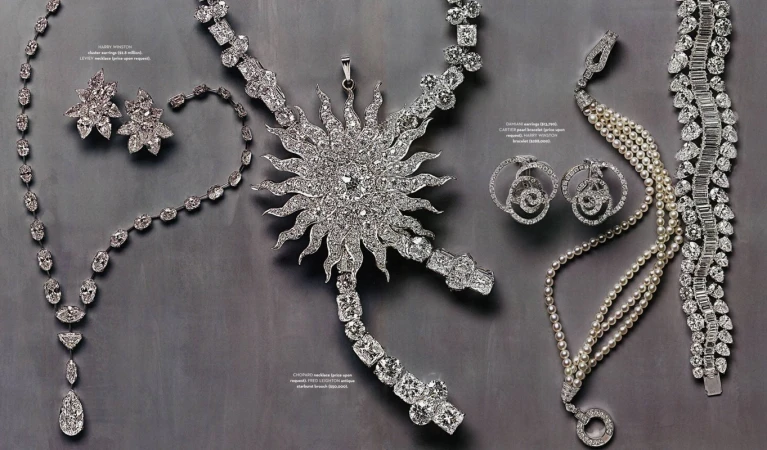 Elegant diamond jewelry collection featuring necklaces, earrings, and bracelets with intricate designs, set against a neutral background.