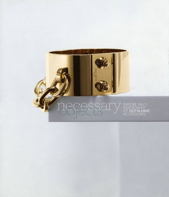 Gold-toned metal Louis Vuitton cuff bracelet with thick chain detail on a white shelf, studio lighting, and clean white background.