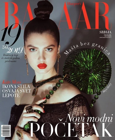 Fashion magazine cover featuring a woman with dark hair and red lipstick, accessorized with large jewelry and holding a green beaded bag.