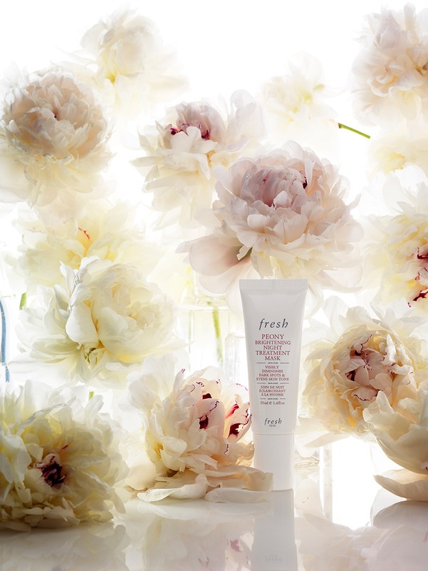 Fresh Peony Brightening Night Treatment Mask tube with white peony flowers, studio shot for skincare and beauty product photography.