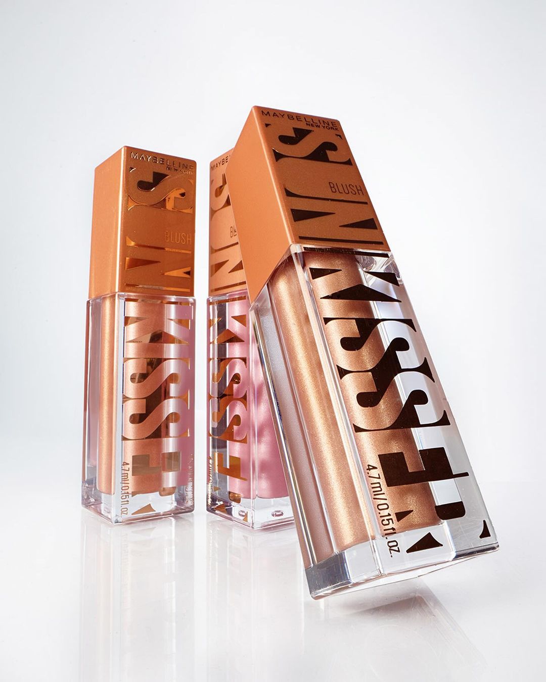 Three Maybelline Sunkisser Blush bottles with a peach and clear package on a white background, perfect for beauty and cosmetics ads.