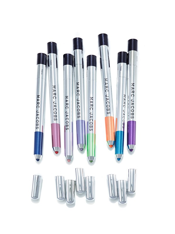 Collection of Marc Jacobs Highliner gel eye crayons in various colors, set against a bright white backdrop in a studio setting.