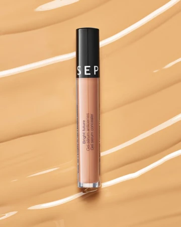 Sephora Bright Future Gel Serum Concealer tube displayed on a textured light brown background, cosmetics, beauty product.