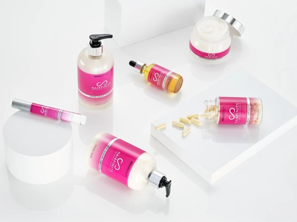 Hairfinity hair care product collection featuring shampoo, conditioner, hair serum, cream, and vitamin supplements on a white background.