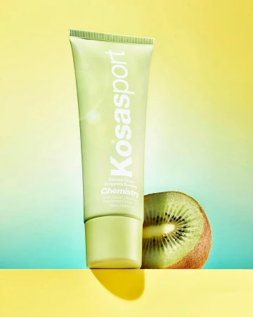 Kosasport Chemistry deodorant product shot with kiwi. Green and yellow studio background highlighting the skincare product.