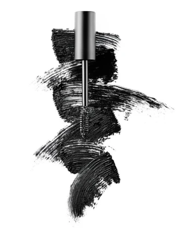 Mascara wand with black mascara smears on a white background, eye makeup product shot for beauty and cosmetics advertising.