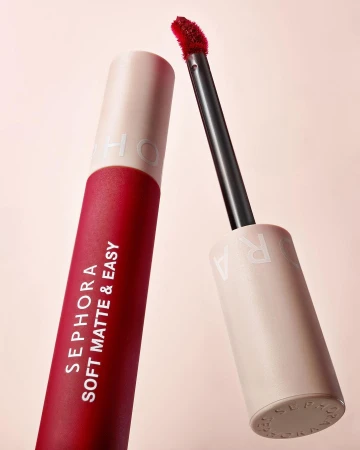 Close-up of Sephora Soft Matte & Easy lip product, featuring a red lipstick tube and applicator against a soft pink background.