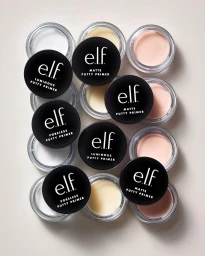 Top-down view of multiple elf putty primer jars with black lids arranged on a neutral background