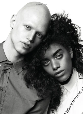 Portrait of two models with heads pressed together against a plain white background styled by Marc Anthony George.