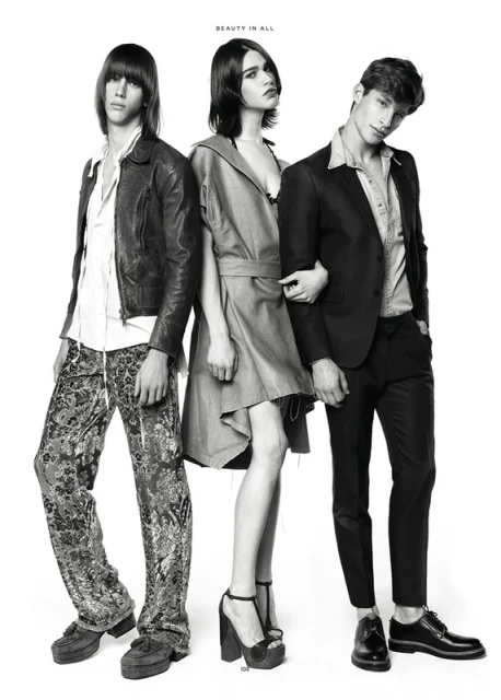 Three fashion models pose in a black-and-white studio shot. Two men and one woman showcase different styles with confident expressions.