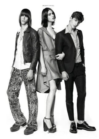 Three fashion models pose in a black-and-white studio shot. Two men and one woman showcase different styles with confident expressions.