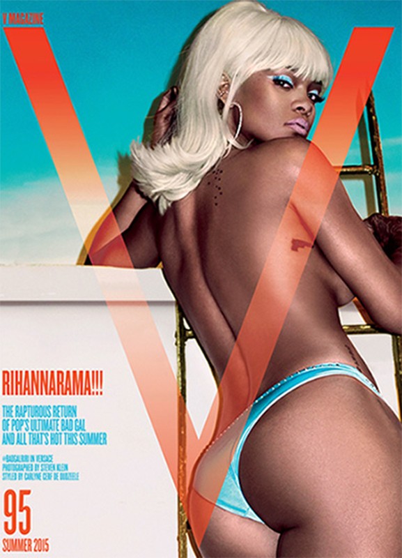 V Magazine cover featuring a woman with a blonde wig, bare back, and light blue bikini bottoms, posing on a white surface with a blue sky background.
