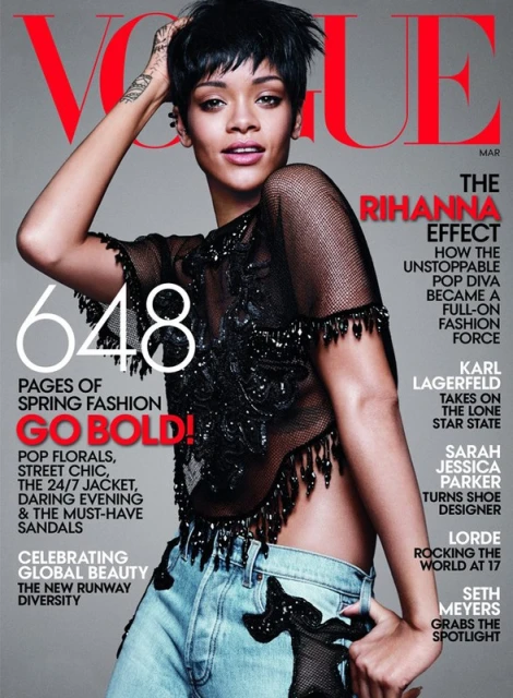 Vogue magazine cover featuring Rihanna wearing a sheer, beaded top and jeans, posing in front of a grey background. 'The Rihanna Effect'.