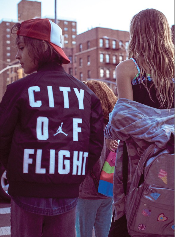Group of youths walking outdoors in Los Angeles with city buildings in the background, styled by Mariah Walker.