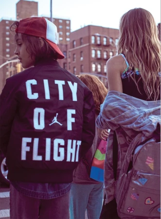 Group of youths walking outdoors in Los Angeles with city buildings in the background, styled by Mariah Walker.