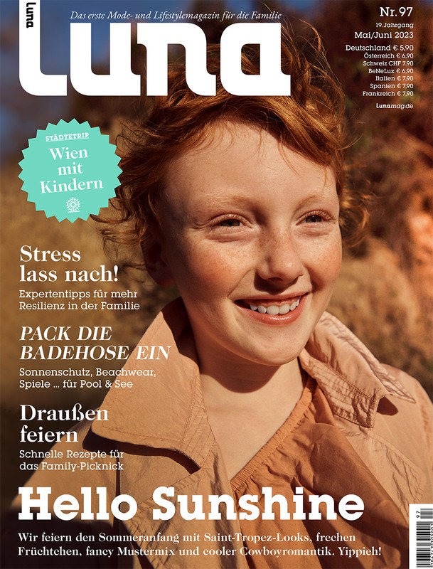 Luna Magazine cover featuring a smiling child with red hair, wearing a tan jacket, and set against an outdoor background with visible text.