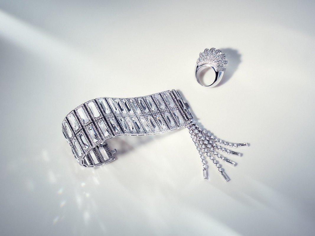 Luxury jewellery still life: diamond bracelet and ring set against a bright white backdrop with soft shadows, showcasing elegance and design.