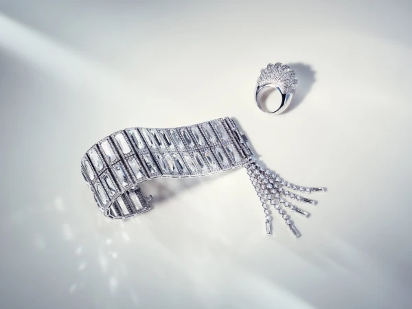 Luxury jewellery still life: diamond bracelet and ring set against a bright white backdrop with soft shadows, showcasing elegance and design.