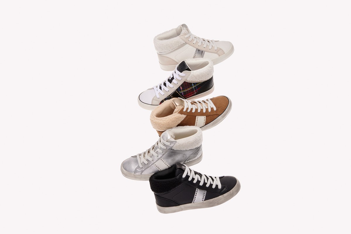 Collection of high-top sneakers in various colors including white, black, tan, and silver, with shearling lining and star accents on white.