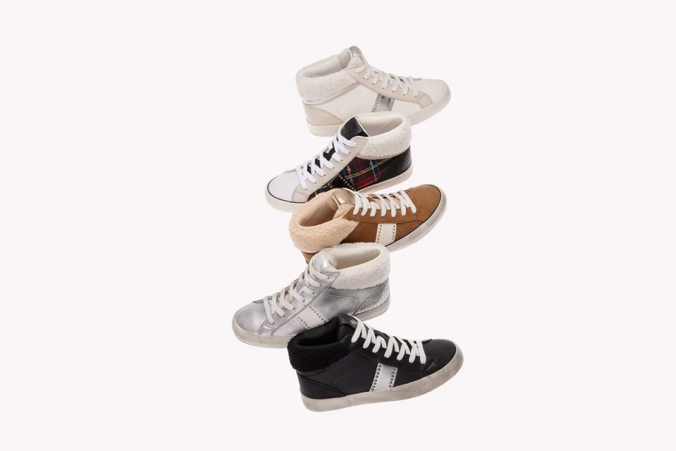 Collection of high-top sneakers in various colors including white, black, tan, and silver, with shearling lining and star accents on white.