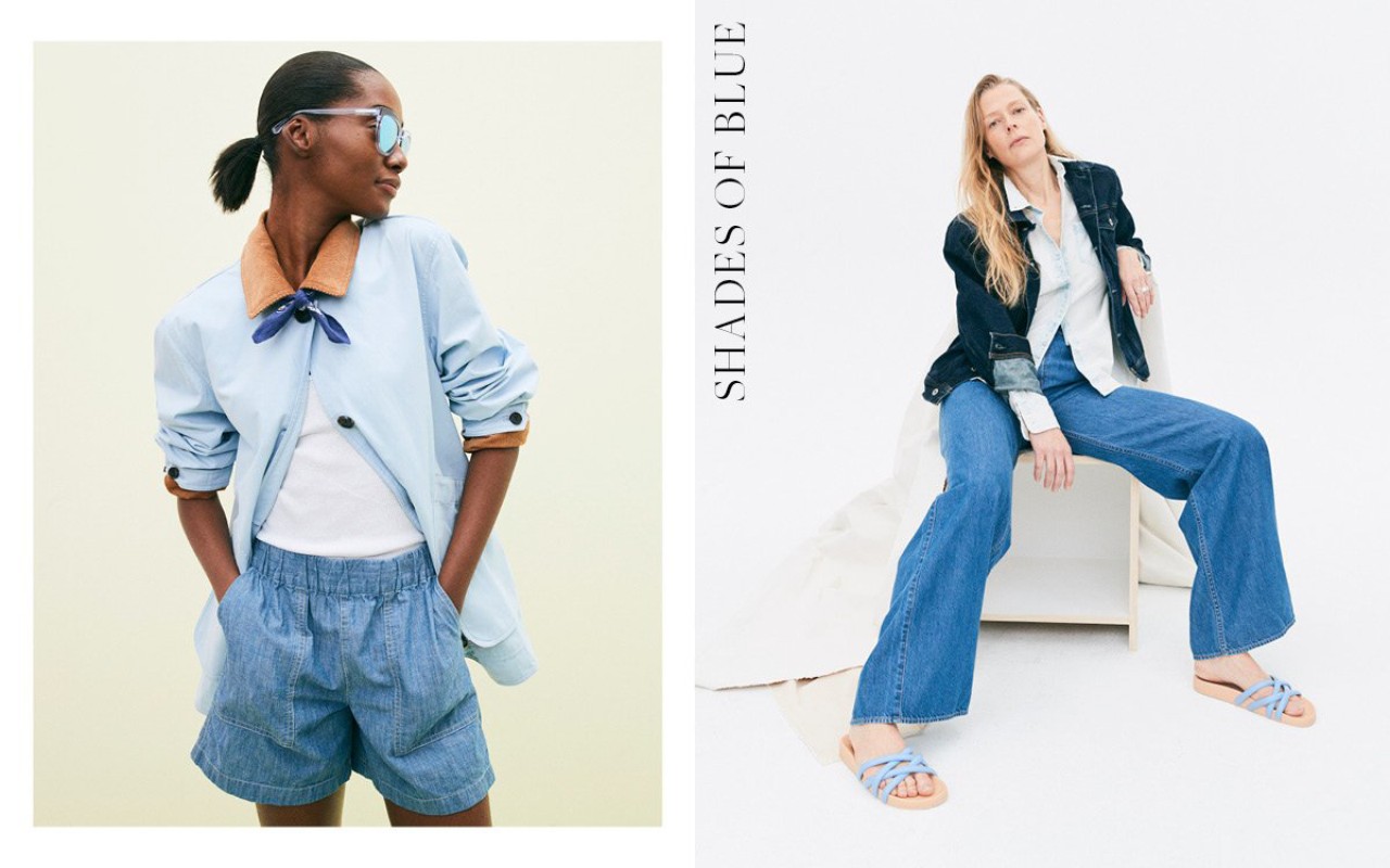 Two women model light-blue denim fashion in a bright photo studio setting. One woman is standing, the other is seated.