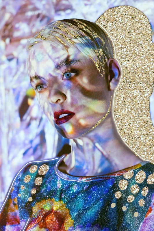 A portrait of a woman with glitter embellishments and vibrant lighting, showcasing beauty and artistic expression through a close-up perspective.