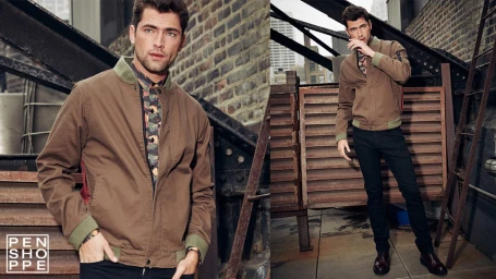 Man wearing a brown bomber jacket and patterned shirt on a rooftop styled by Matthew Edelstein