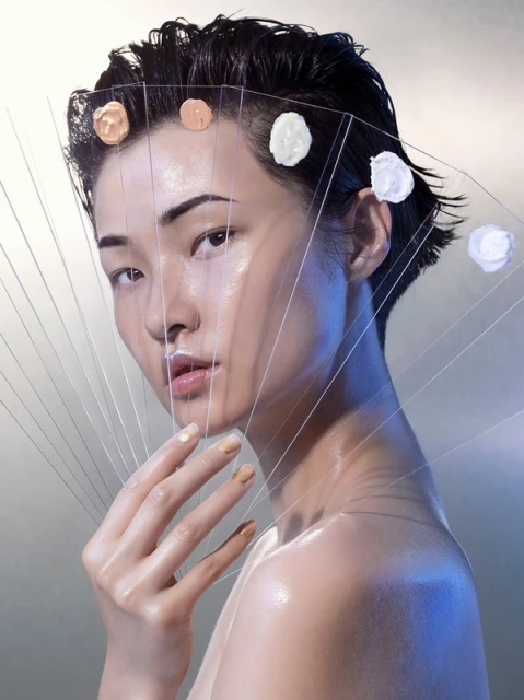 Asian woman with clear palette and foundation samples in a beauty shot against a gradient background, emphasizing skincare and makeup artistry.