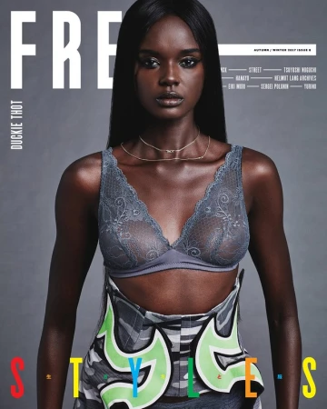 Magazine cover featuring a dark-skinned woman with long black hair, wearing a grey lace bra and a graffiti-style skirt with bright colors.